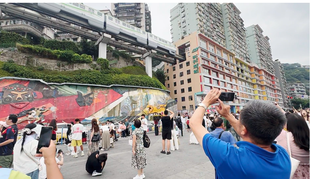 A person taking a picture of a crowd of people AI-generated content may be incorrect.