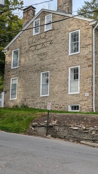 Historic stone building beside a road