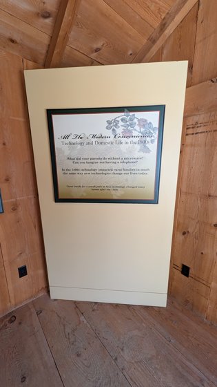Museum display panel in a wooden room
