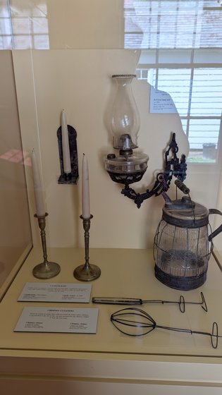 Candlesticks and lamps in a museum display