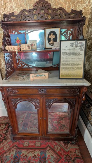 Decorated historic cabinet and interpretation panel