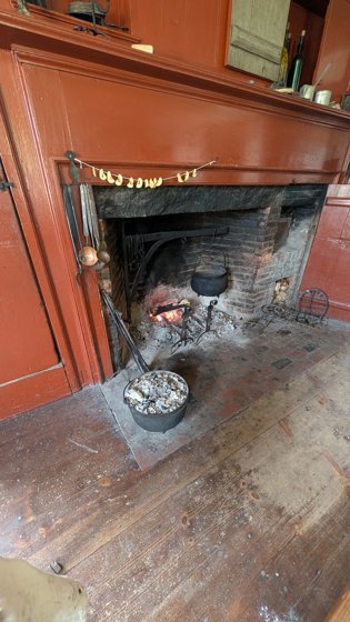 Historic hearth with pots and cooking equipment